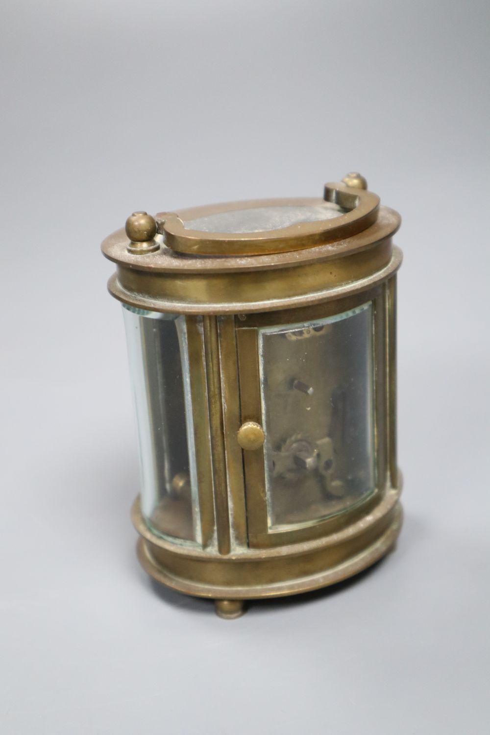 An oval brass carriage timepiece inscribed Elliott & Sons, London